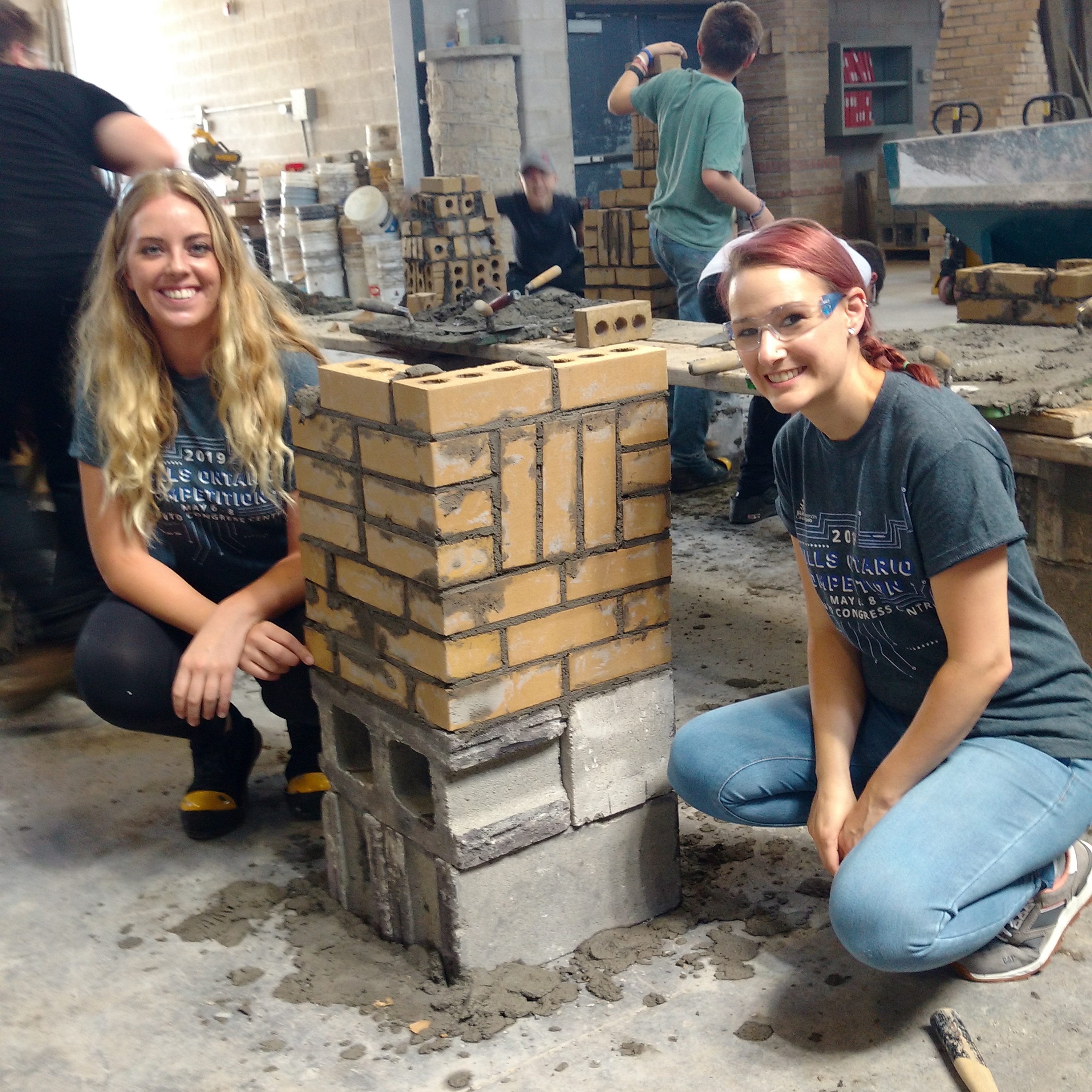 A counsellor and camper pose by a campers project during a Skills Ontario Regional Summer Camp session.