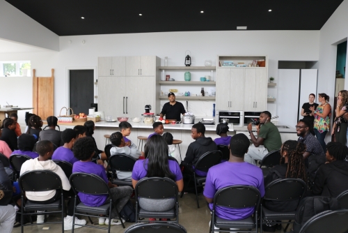 Participants watch a cooking demonstration with Roger Mooking.